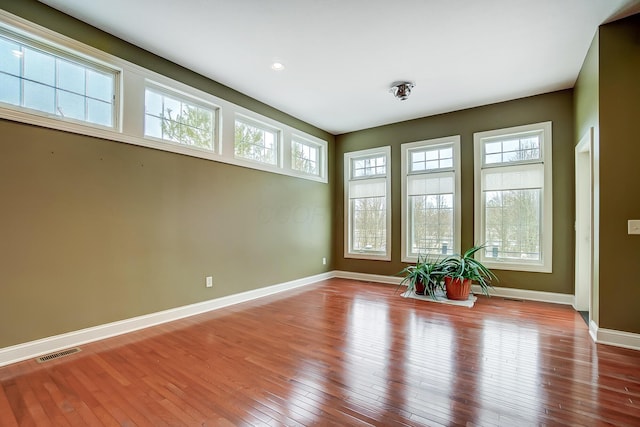 unfurnished room with plenty of natural light and light wood-type flooring