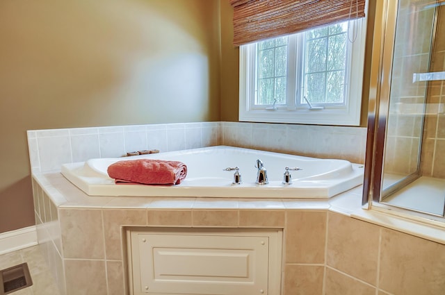 bathroom featuring tiled bath