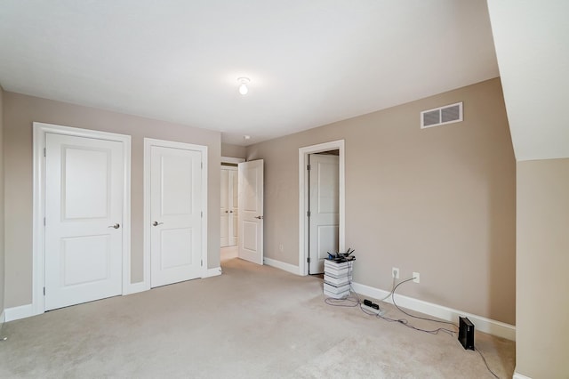 unfurnished bedroom with light carpet