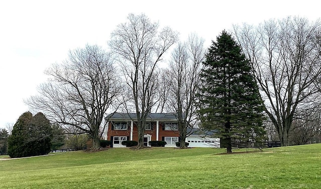 view of front of house with a garage and a front yard