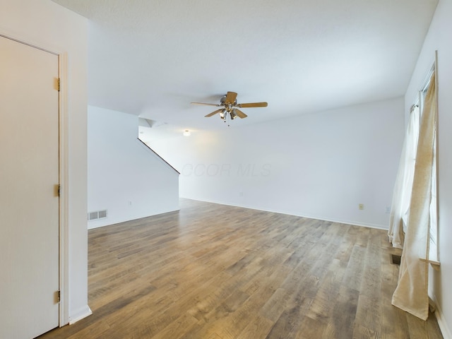 empty room with hardwood / wood-style floors and ceiling fan