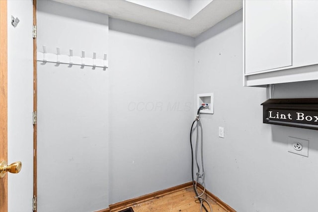 laundry room featuring hookup for a washing machine, cabinets, and hardwood / wood-style flooring