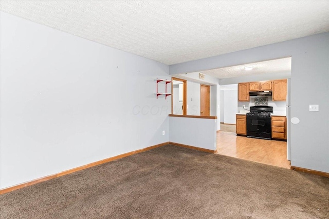 unfurnished living room featuring light carpet and a textured ceiling