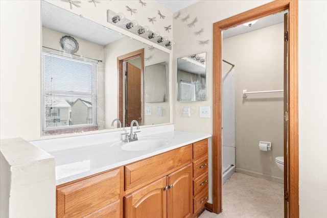 bathroom with vanity and toilet