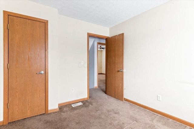 interior space with carpet and a textured ceiling