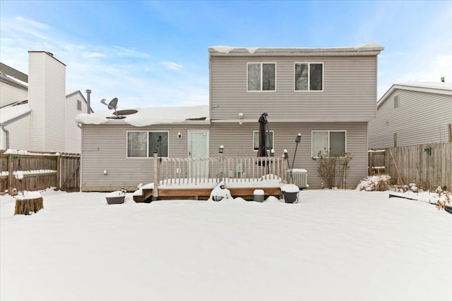 snow covered house featuring a deck