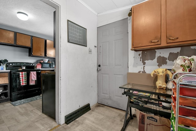 kitchen featuring electric range and a textured ceiling