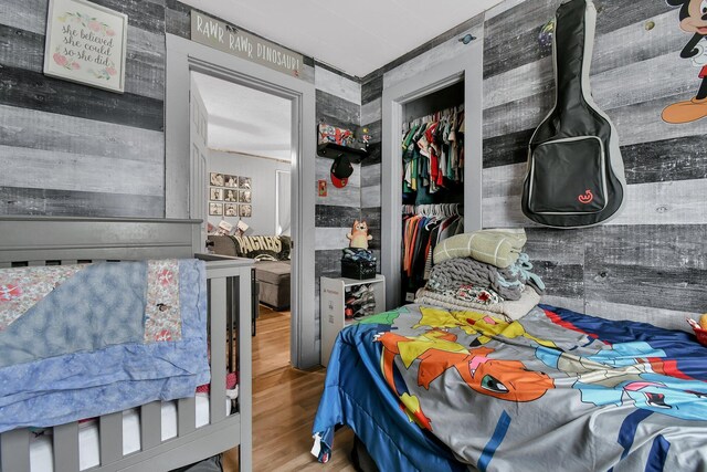 bedroom with wood-type flooring and a closet