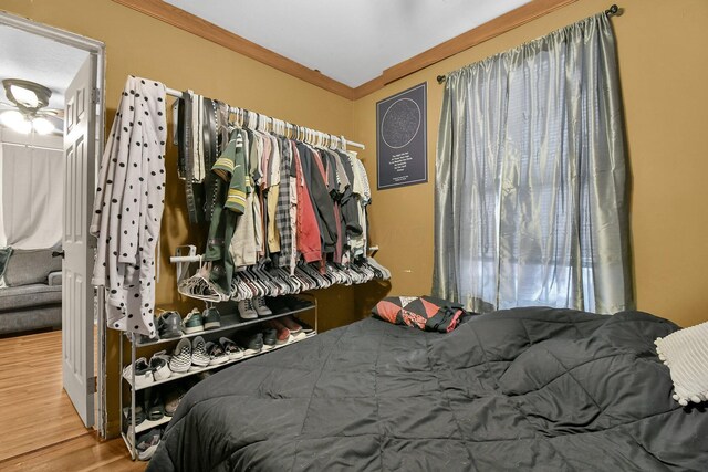 bedroom with wood-type flooring and crown molding