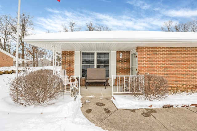 view of snow covered property entrance