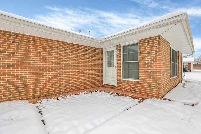 view of snow covered property entrance