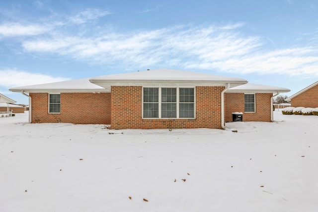 view of snow covered rear of property