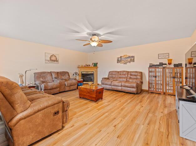 living room featuring light hardwood / wood-style floors and ceiling fan