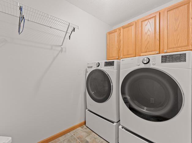 washroom with cabinets and independent washer and dryer