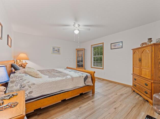 bedroom featuring ceiling fan and light hardwood / wood-style flooring