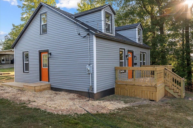 back of house featuring a deck