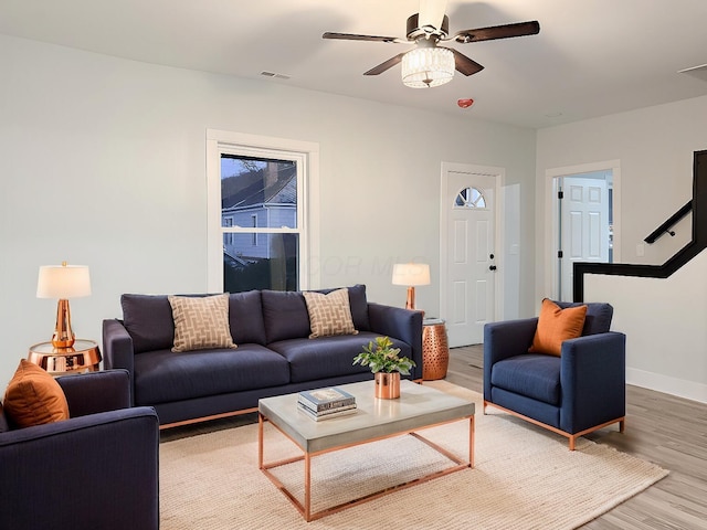 living room featuring hardwood / wood-style flooring and ceiling fan