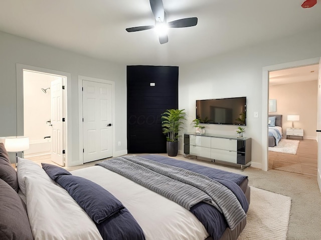 carpeted bedroom featuring connected bathroom and ceiling fan