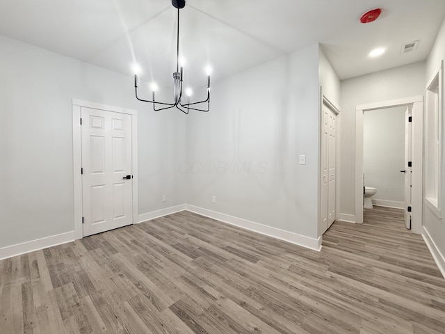 unfurnished dining area featuring light wood-type flooring