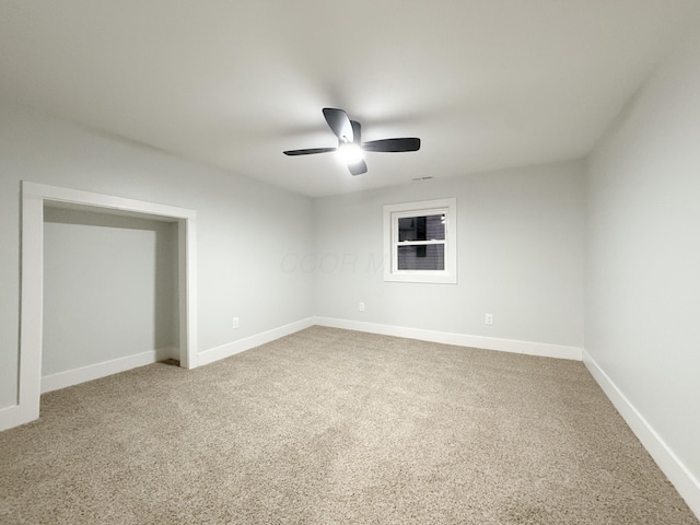 unfurnished room with carpet flooring and ceiling fan