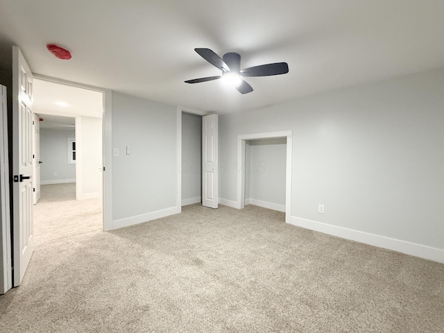 unfurnished bedroom featuring light colored carpet and ceiling fan