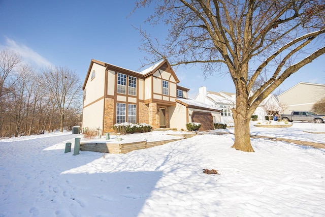 tudor-style house featuring a garage