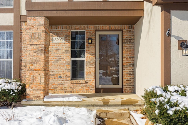 view of snow covered property entrance