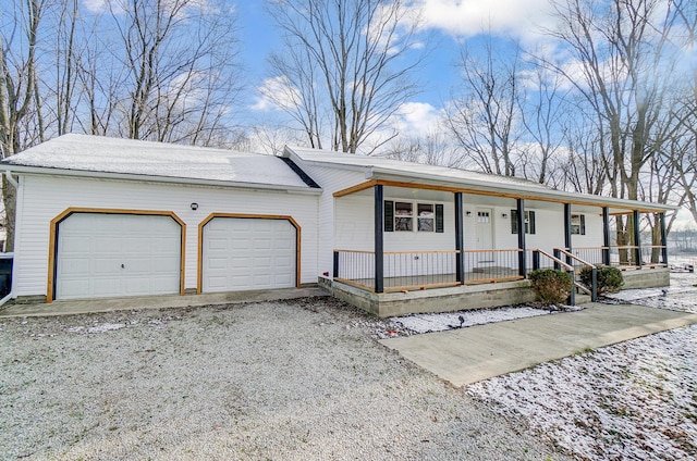 ranch-style home featuring a garage and covered porch