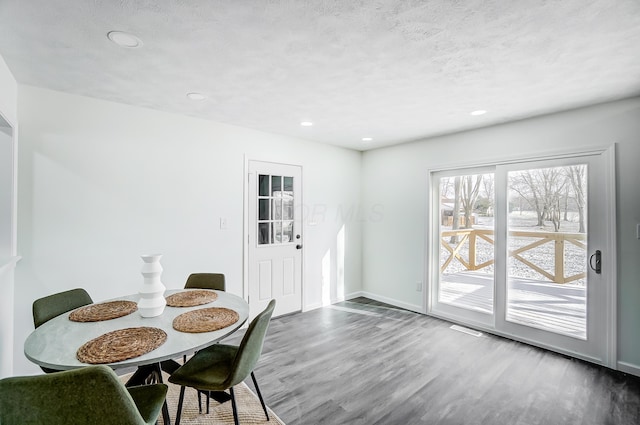 dining space with dark hardwood / wood-style flooring