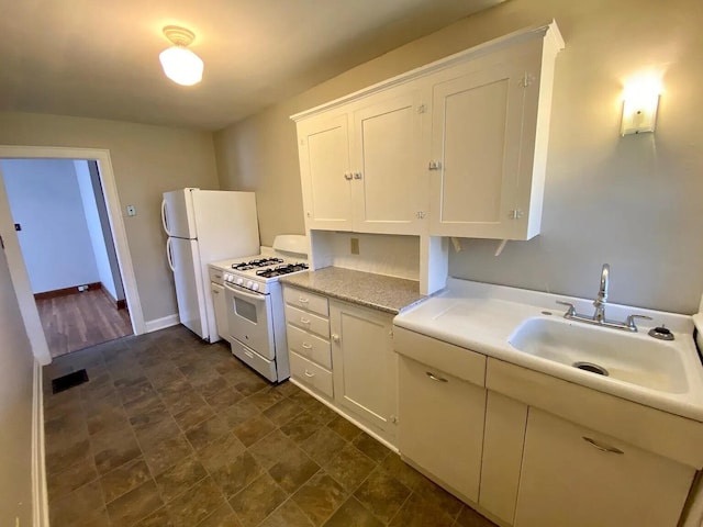 kitchen with white cabinets, white appliances, and sink