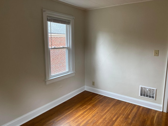 empty room with dark hardwood / wood-style flooring