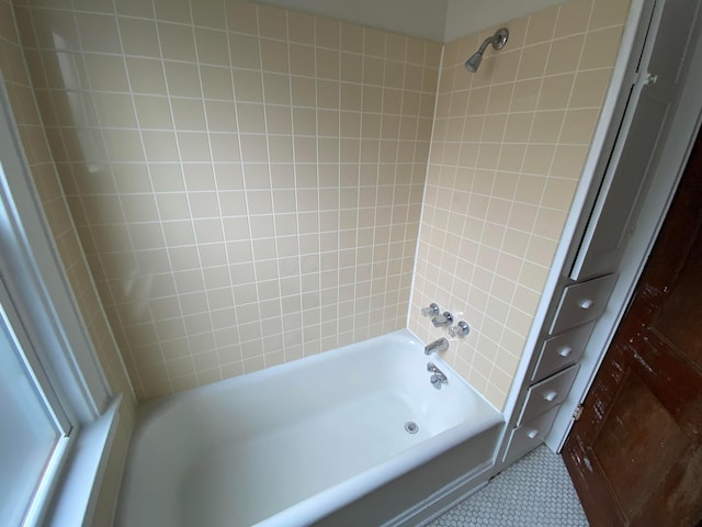 bathroom with tile patterned floors and tiled shower / bath combo