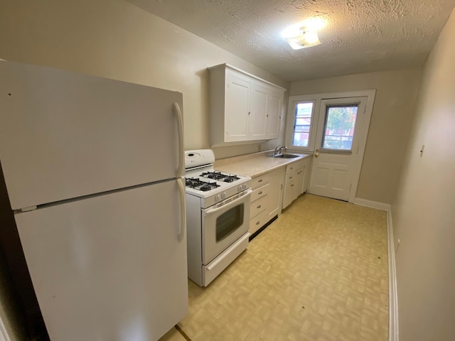 kitchen with a textured ceiling, white cabinetry, sink, and white appliances