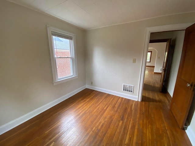 spare room with dark wood-type flooring