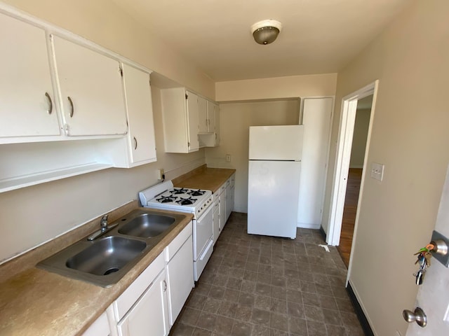 kitchen featuring white appliances, ventilation hood, white cabinetry, and sink