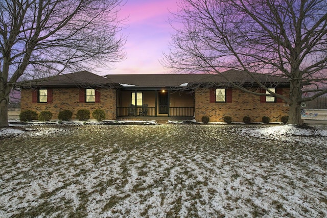 ranch-style house with brick siding and a porch