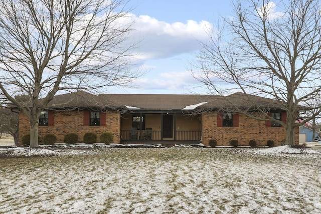 single story home featuring covered porch and brick siding