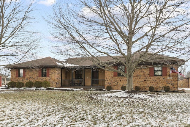 ranch-style house with covered porch and brick siding