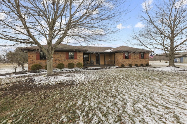 ranch-style home featuring a porch and brick siding