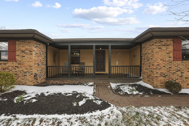 view of front of home with covered porch and brick siding