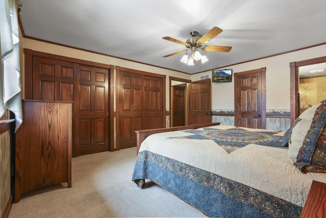 bedroom featuring ornamental molding, light colored carpet, and visible vents