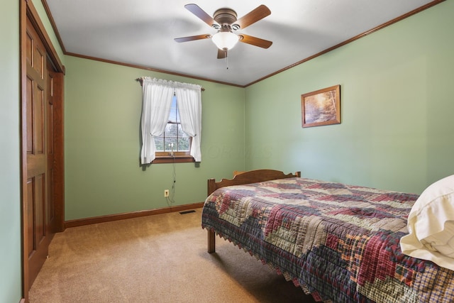 bedroom with carpet, visible vents, crown molding, and baseboards