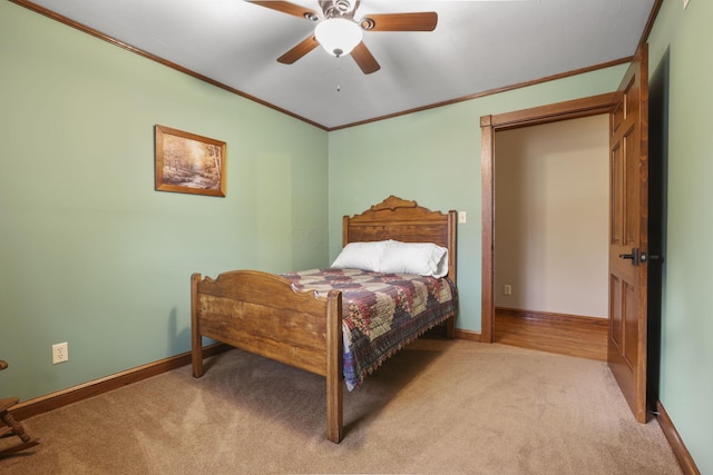 bedroom featuring ornamental molding, light colored carpet, ceiling fan, and baseboards