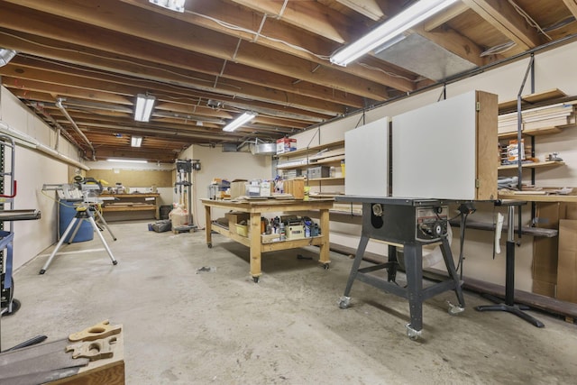 unfinished basement featuring a workshop area