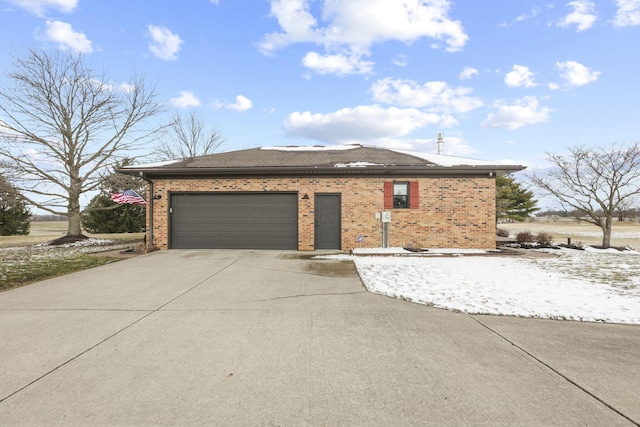 view of front facade featuring brick siding, driveway, and an attached garage