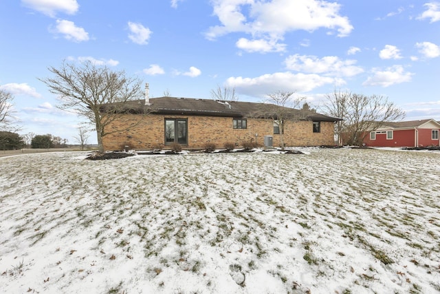 back of house featuring brick siding