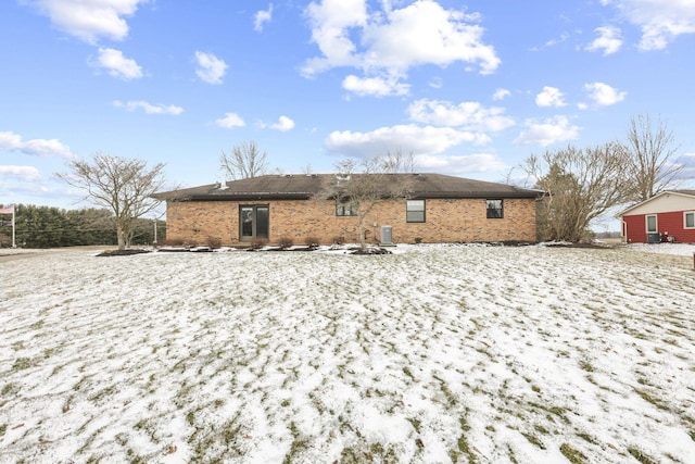 rear view of property with brick siding