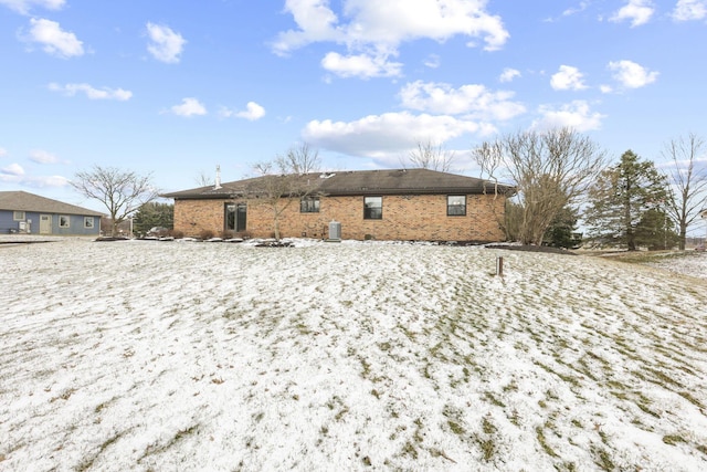 rear view of property with brick siding