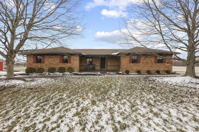 single story home featuring covered porch and brick siding