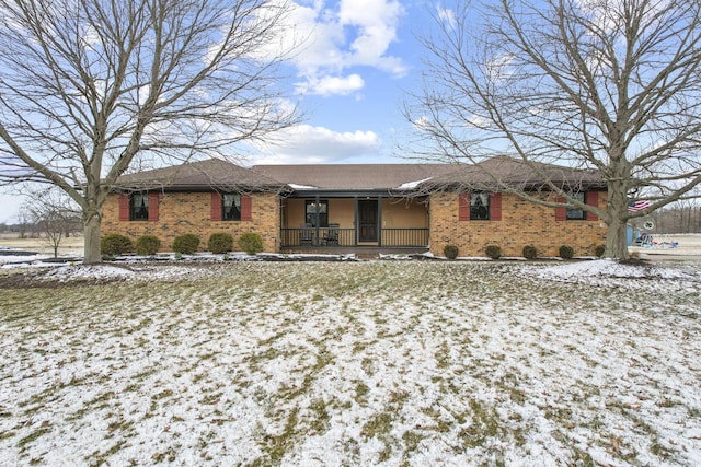 ranch-style house with covered porch and brick siding